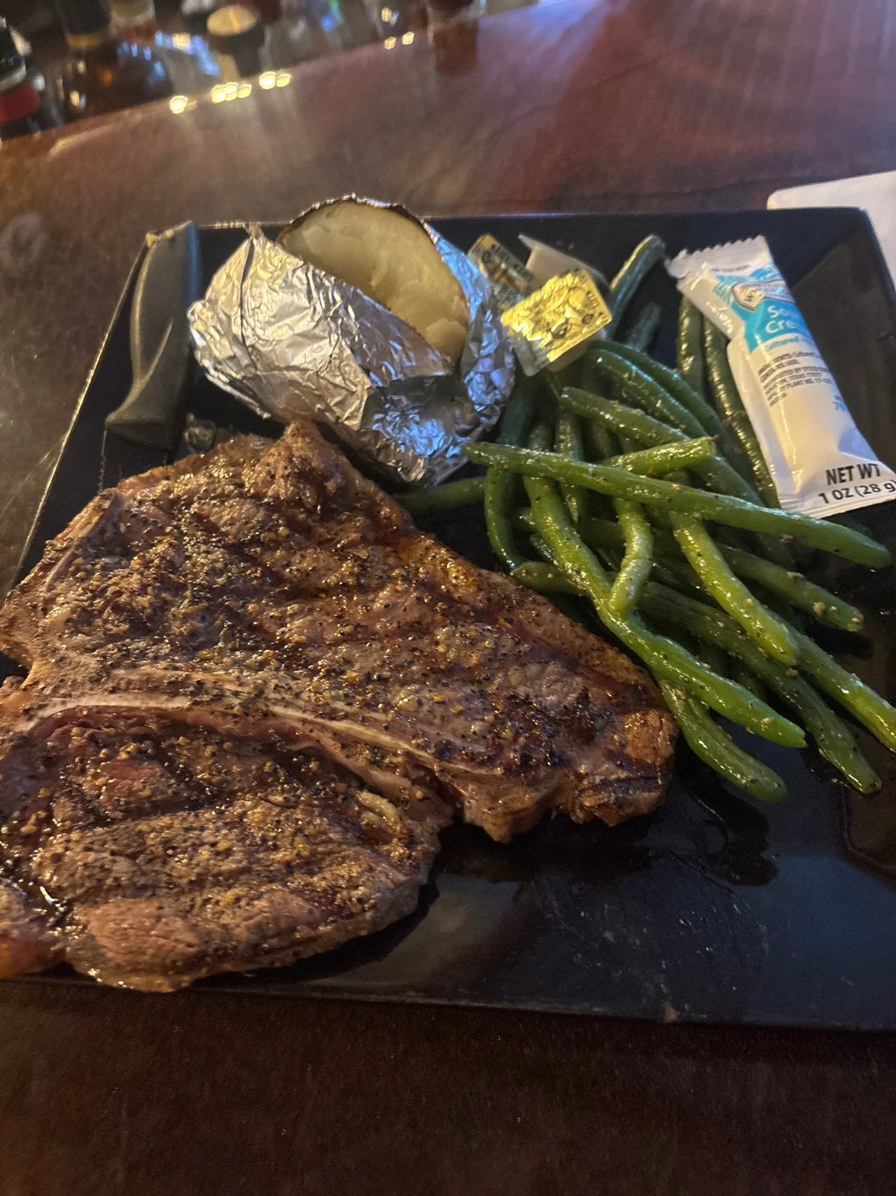 Kings T-bone steak with baked potato and green beans