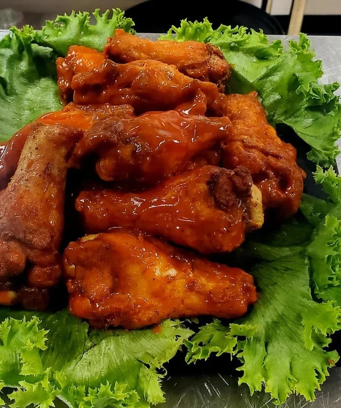 Real Kings sauced chicken wings on lettuce