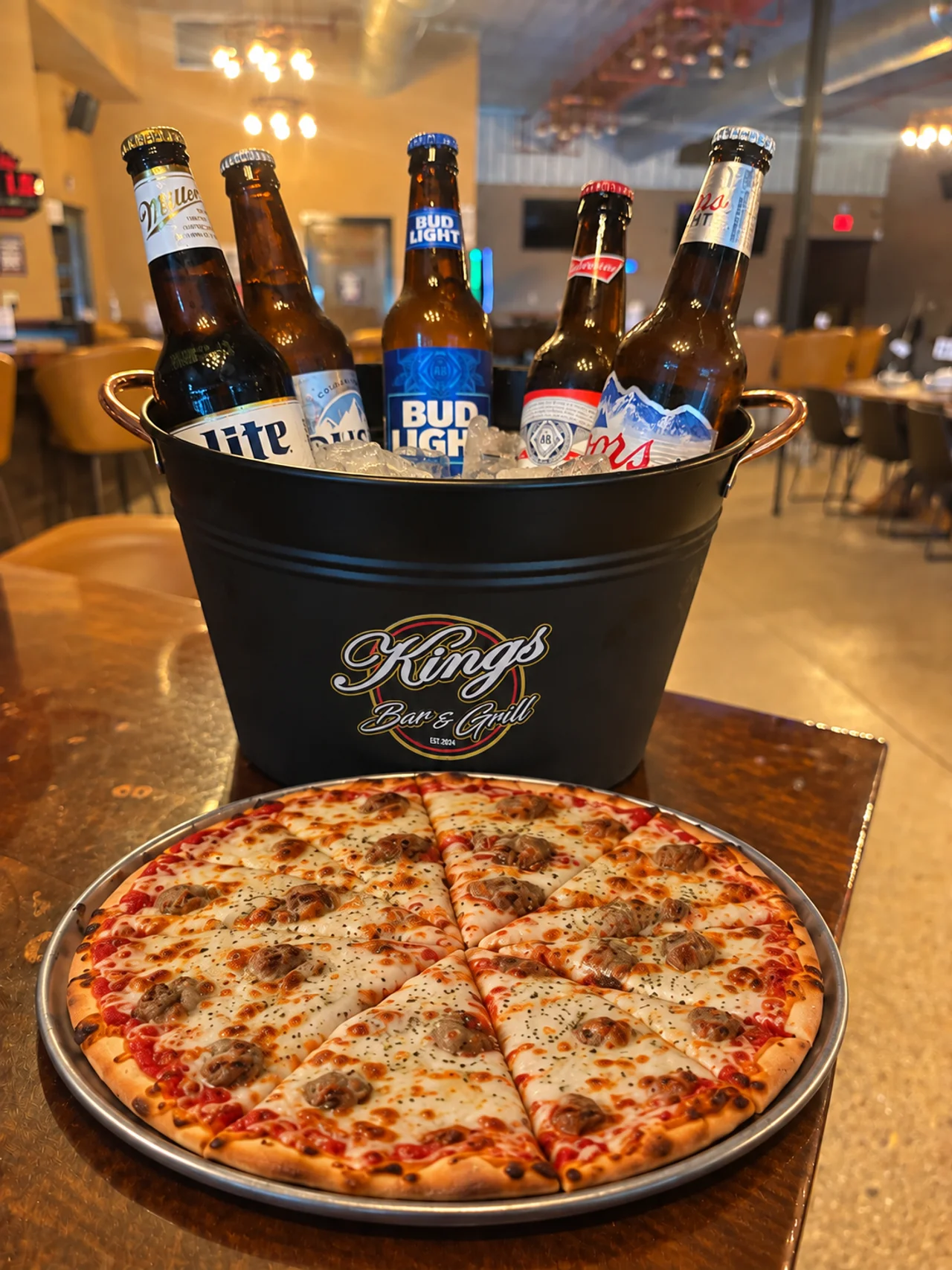 Kings-inspired promotional image of a 12-inch personal pizza beside a branded beer bucket